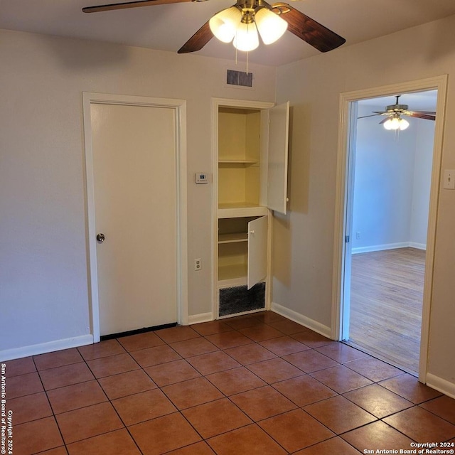 unfurnished room featuring ceiling fan and dark hardwood / wood-style floors