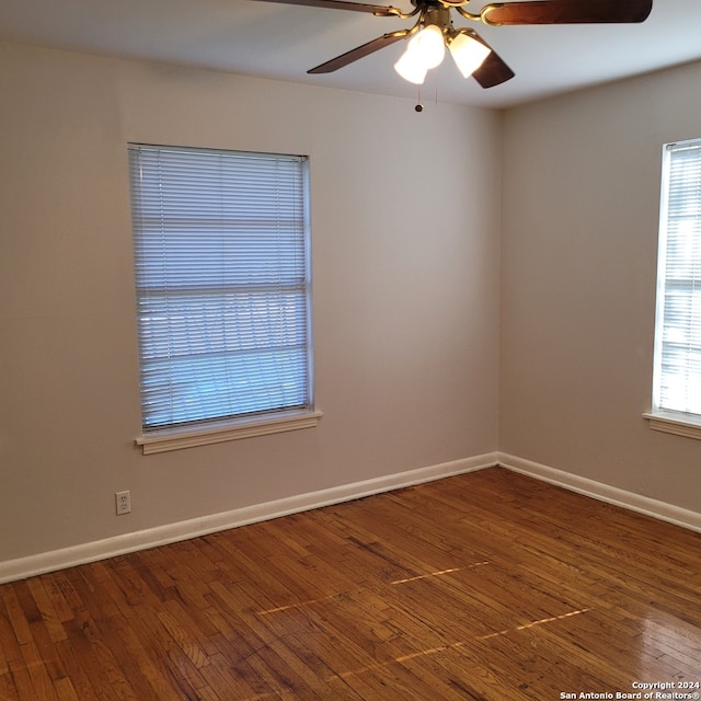 empty room featuring ceiling fan and dark wood-type flooring