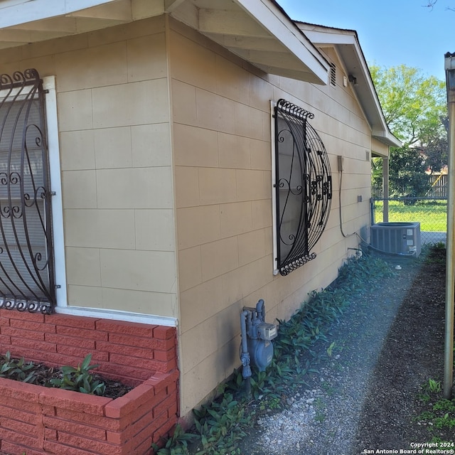 view of side of property featuring central AC