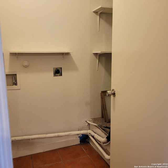 clothes washing area with electric dryer hookup, hookup for a washing machine, and dark tile flooring