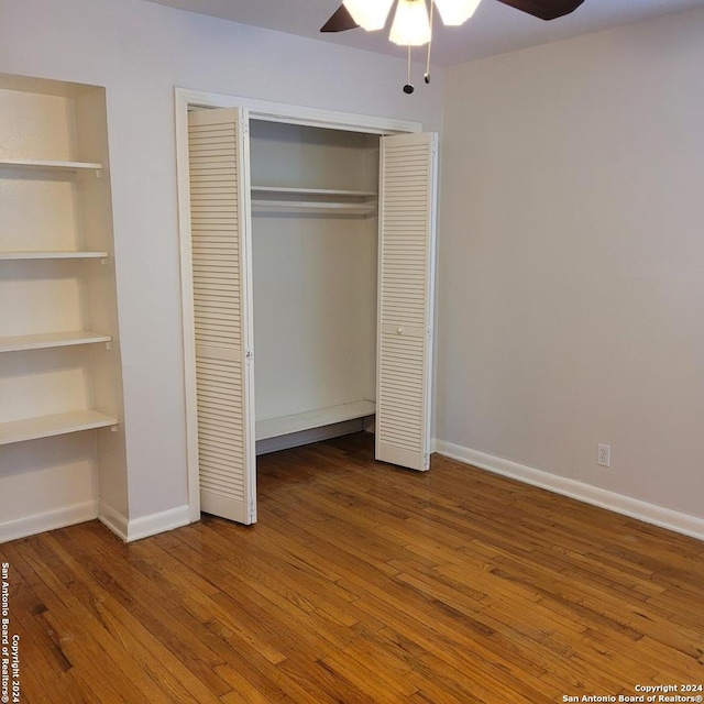 unfurnished bedroom featuring ceiling fan and dark wood-type flooring