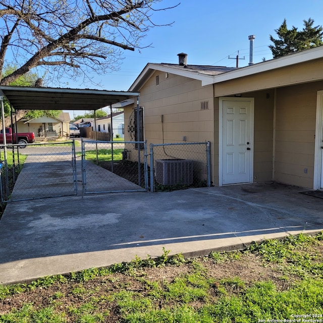 view of property exterior with central AC unit and a carport