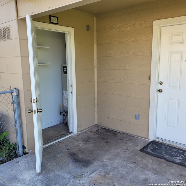 view of exterior entry featuring gas water heater