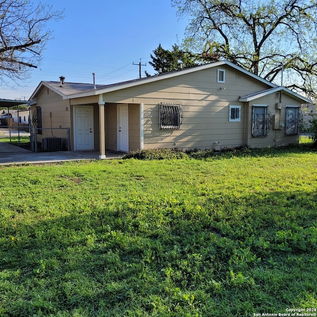 ranch-style house featuring central AC and a front yard