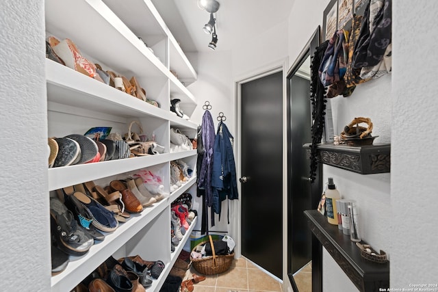 spacious closet with light tile flooring