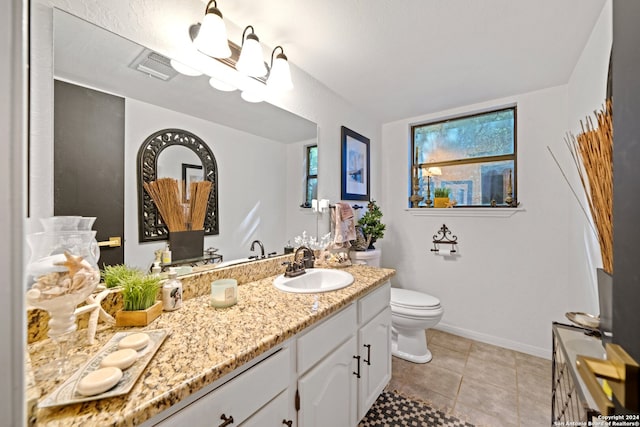 bathroom with toilet, tile floors, and vanity