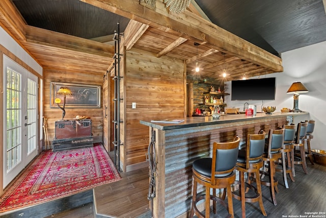 bar featuring wooden walls, vaulted ceiling, wood ceiling, dark hardwood / wood-style floors, and french doors