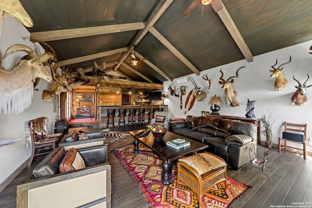 living room with dark wood-type flooring, ceiling fan, and beamed ceiling