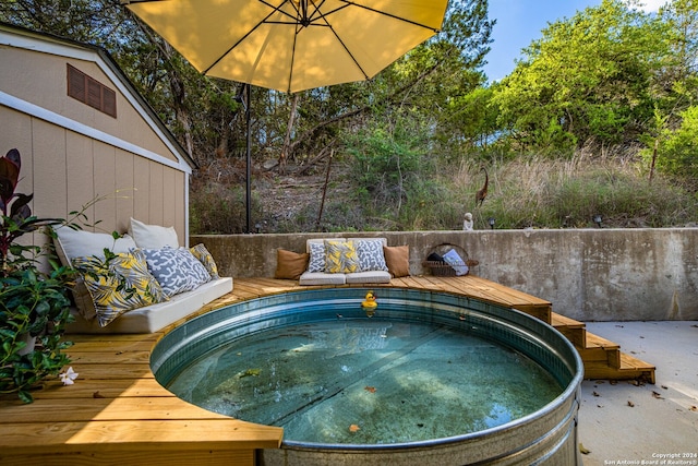 view of swimming pool featuring a deck and a jacuzzi