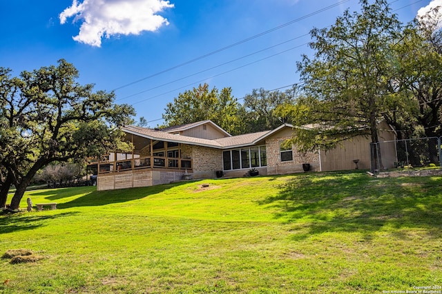 rear view of property featuring a yard