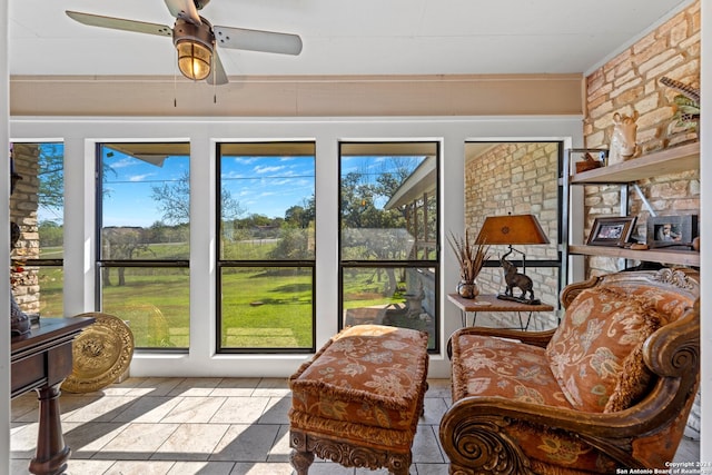 sunroom featuring ceiling fan