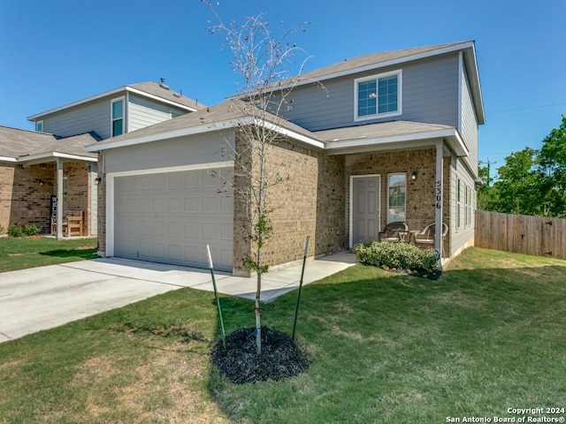 view of front property featuring a front yard and a garage