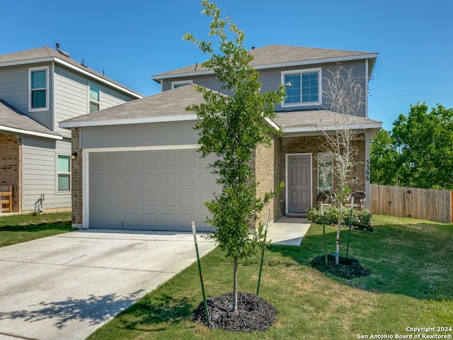 view of front of home with a garage and a front yard