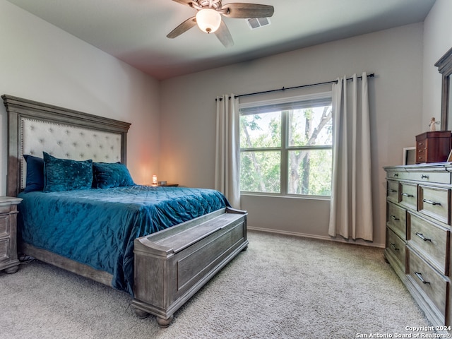 bedroom featuring light carpet and ceiling fan