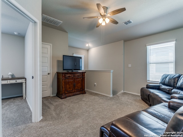 living room with light colored carpet and ceiling fan