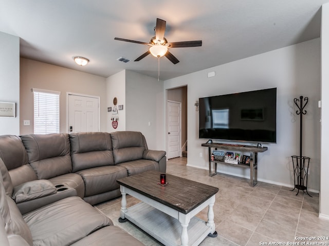 tiled living room with ceiling fan