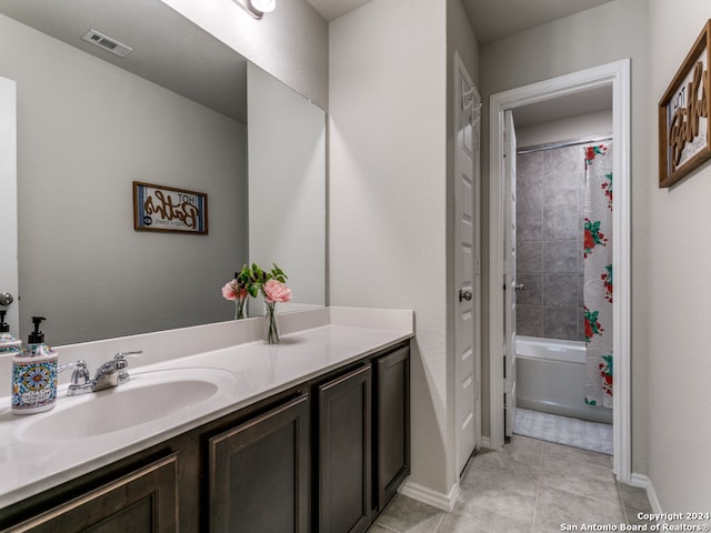 bathroom with tile flooring, large vanity, and shower / bath combo with shower curtain