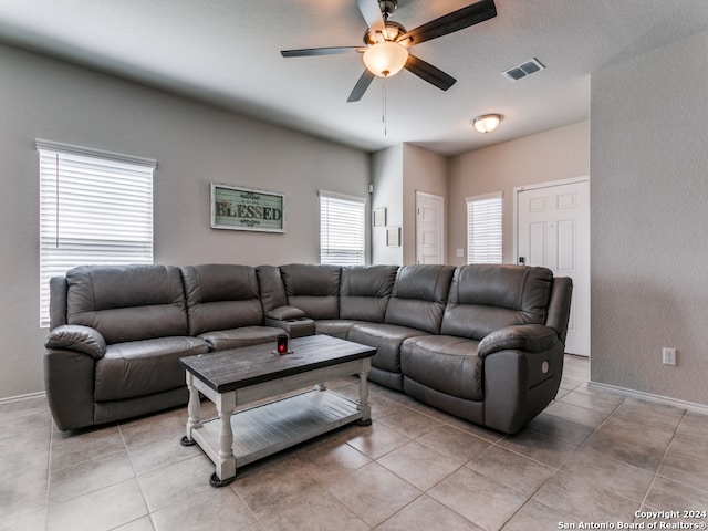 living room featuring ceiling fan and light tile floors