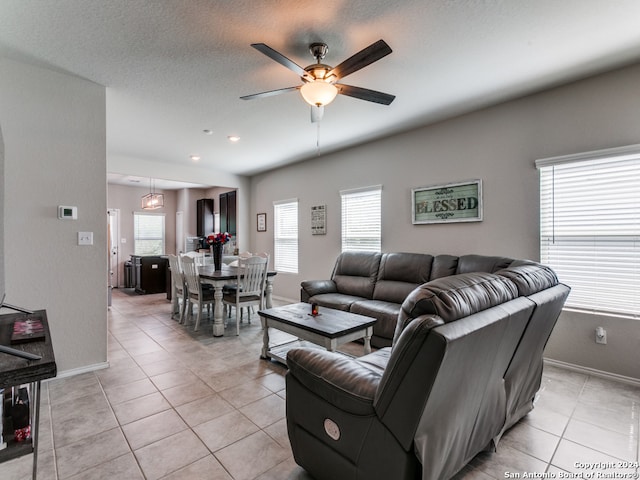 tiled living room featuring plenty of natural light, ceiling fan, and a textured ceiling