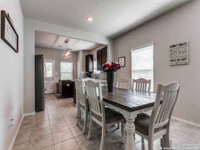 dining space with light tile flooring