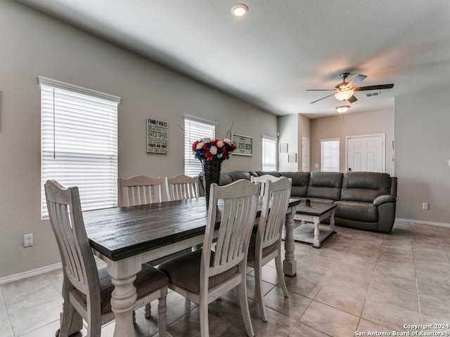 dining room with plenty of natural light, ceiling fan, and light tile floors