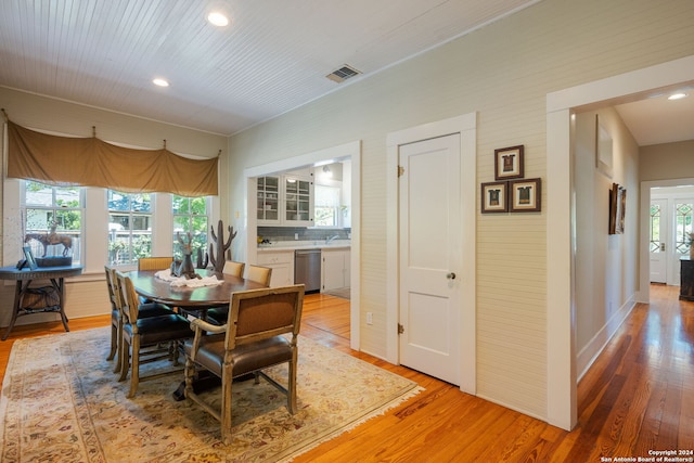 dining space with sink and light wood-type flooring