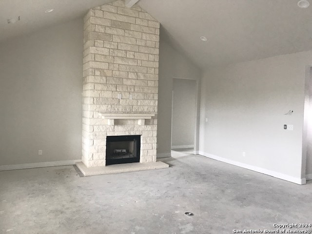 unfurnished living room featuring brick wall, a fireplace, and lofted ceiling