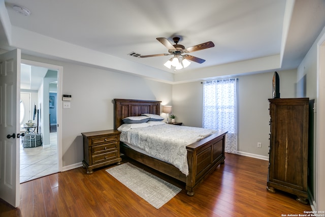 tiled bedroom featuring ceiling fan