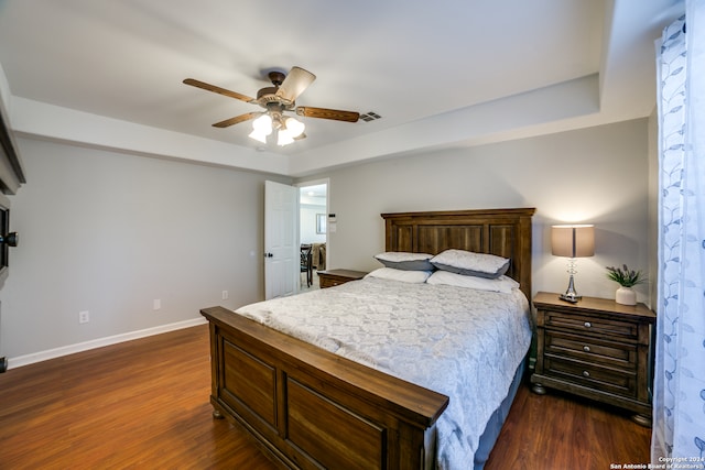 bedroom with dark hardwood / wood-style floors and ceiling fan