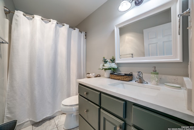 bathroom featuring toilet, vanity, and tile floors