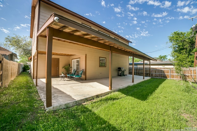 back of property with a patio and a lawn