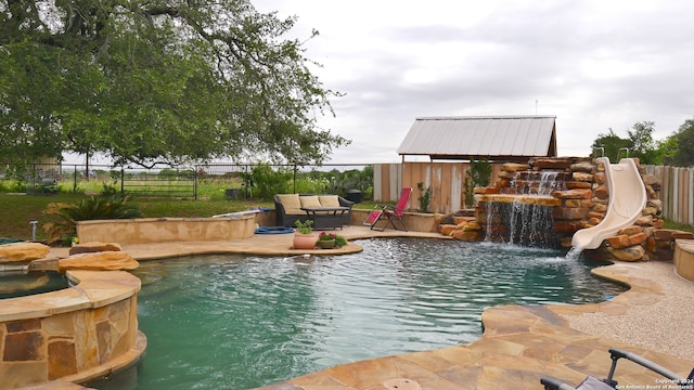 view of swimming pool featuring a water slide and pool water feature