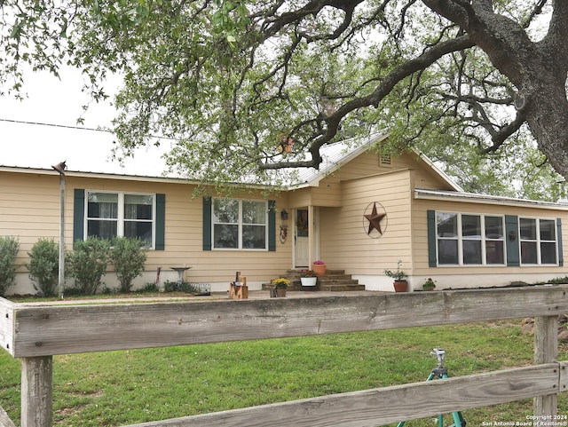 ranch-style home featuring a front yard