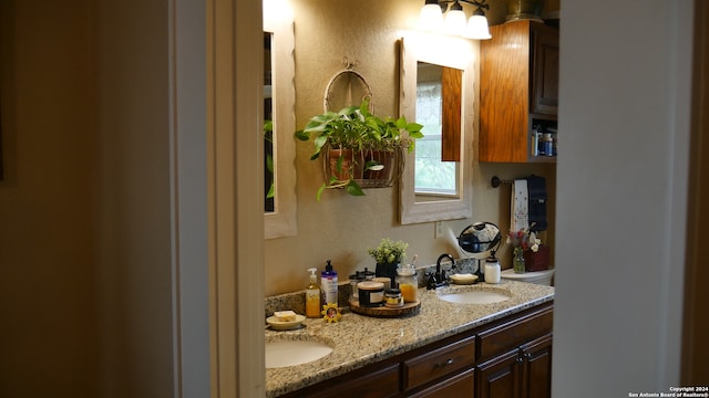 bathroom with dual sinks and oversized vanity