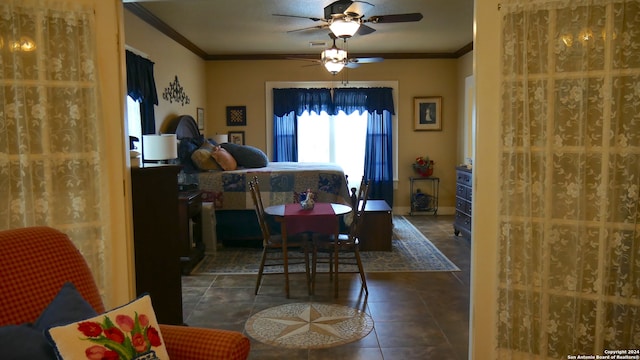 tiled dining space with ornamental molding and ceiling fan