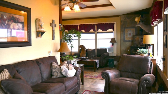 living room featuring dark tile flooring and ceiling fan