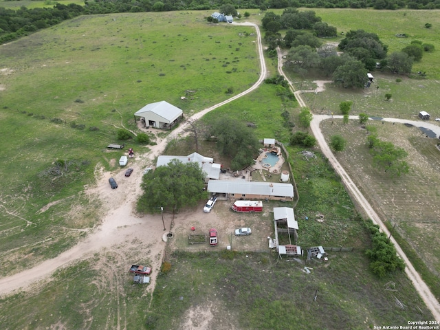 birds eye view of property with a rural view