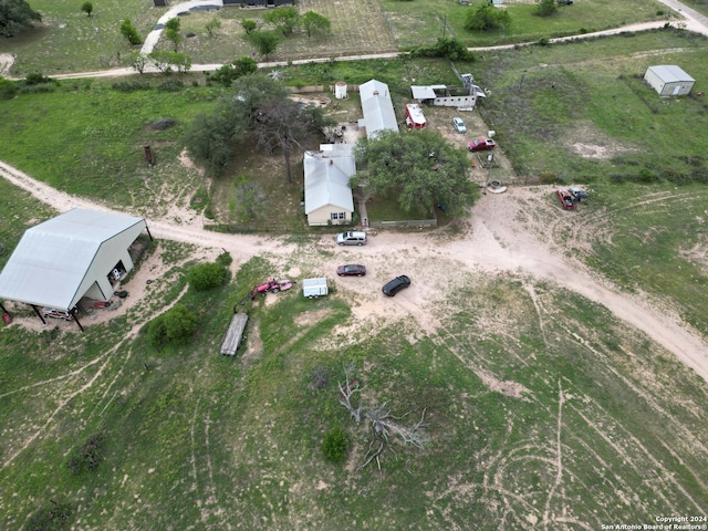 birds eye view of property with a rural view