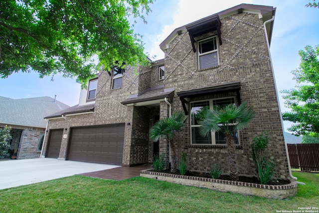 view of front facade with a front yard and a garage