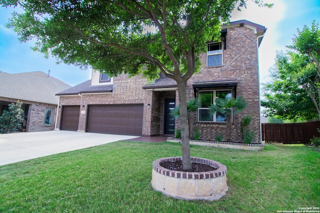 view of front of house featuring a front lawn and a garage