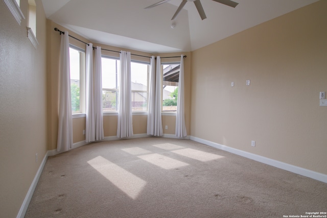 spare room with light carpet, ceiling fan, and high vaulted ceiling