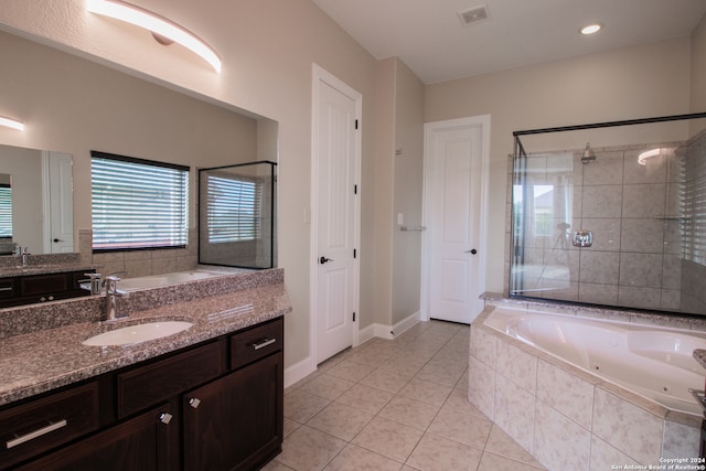 bathroom featuring tile flooring, vanity, and independent shower and bath