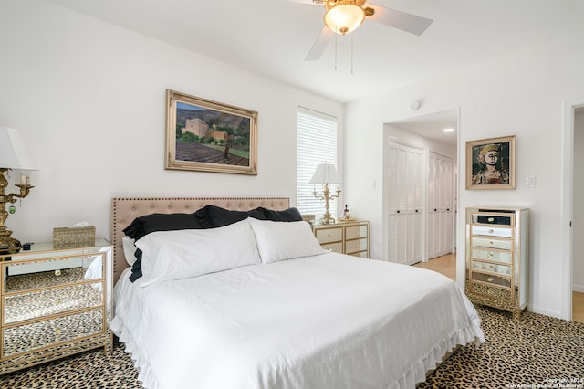 carpeted bedroom with ceiling fan and a closet