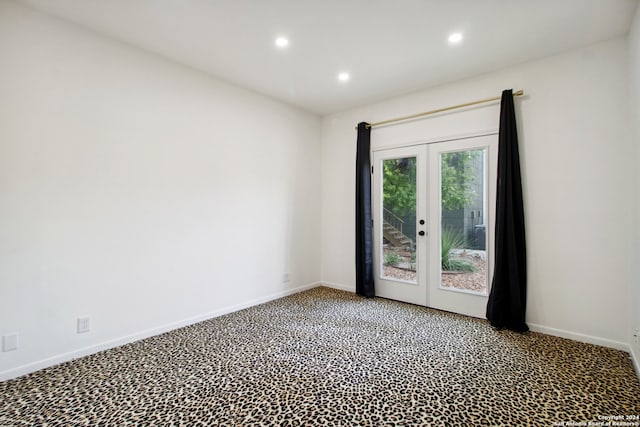 carpeted empty room featuring french doors