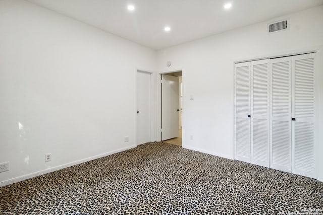 unfurnished bedroom featuring carpet floors and a closet