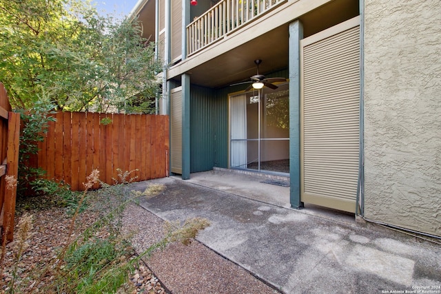 view of patio with ceiling fan and a balcony