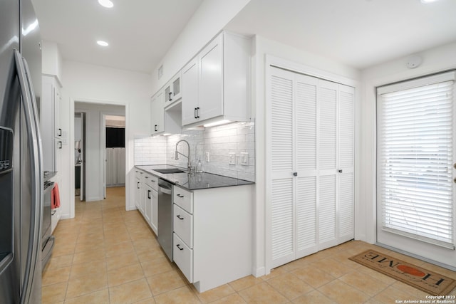 kitchen with white cabinets, appliances with stainless steel finishes, sink, and a healthy amount of sunlight