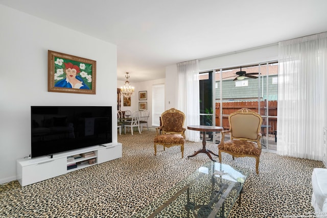 carpeted living room featuring a fireplace and ceiling fan with notable chandelier