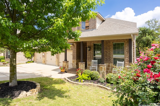 view of front of home with a front yard and a garage