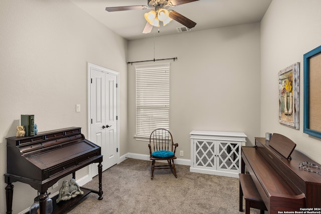 living area with ceiling fan and light carpet